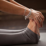 Closeup of yogi woman in Seated forward bend exercise